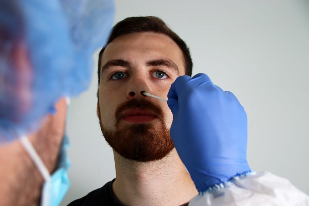 A man having a nasal swab test done